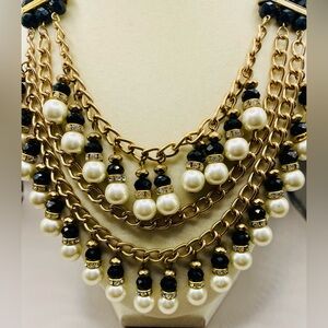 Layered faux pearl, black bead and rhinestone bib statement necklace. Gold tone